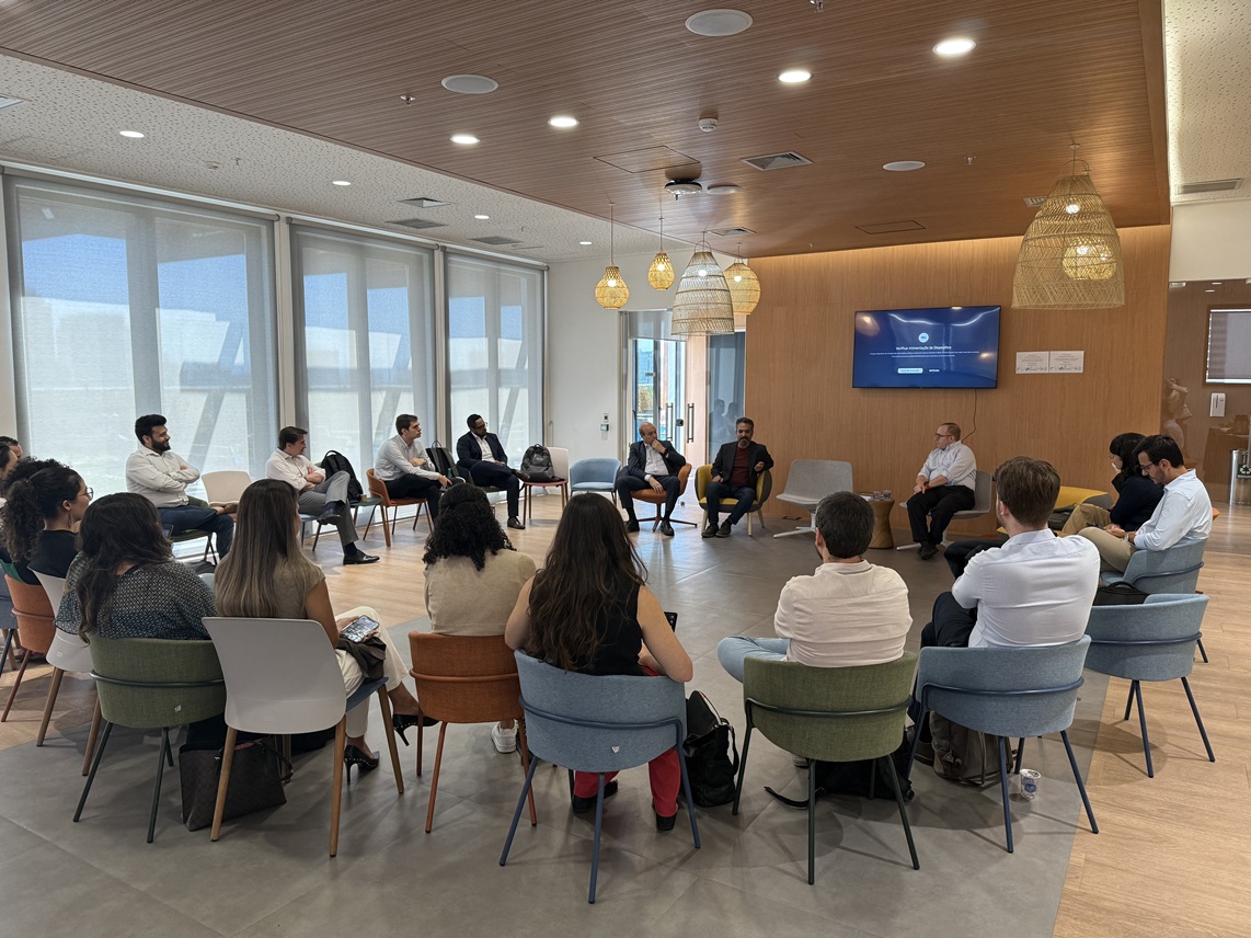 A roundtable session with students and faculty in a bright university space